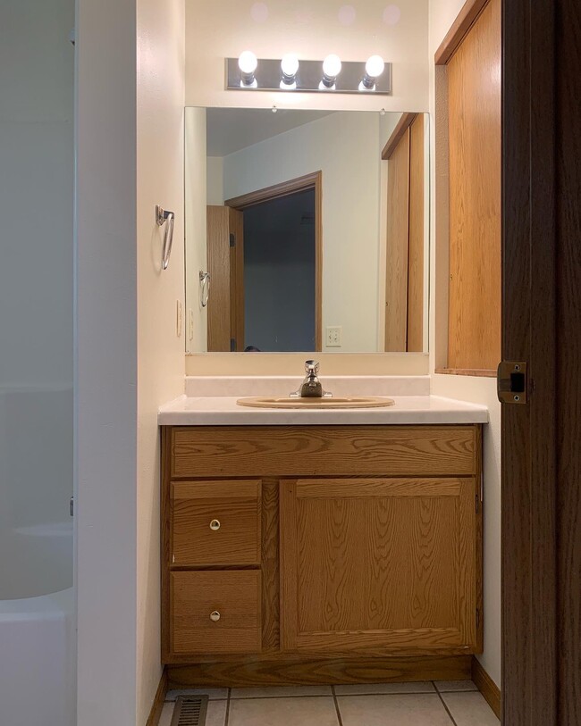 2 full baths - one up and one down. Bath feature tile flooring, new paint - very clean! - 1716 5th St E