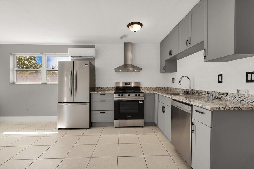 Newly renovated modern kitchen with stainless steel appliances and modern cabinets - 249 SW 12th St