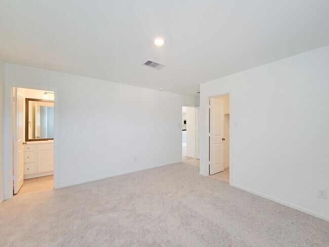 Building Photo - This single-level home showcases a spacious open floorplan shared between the kitchen, dining are...