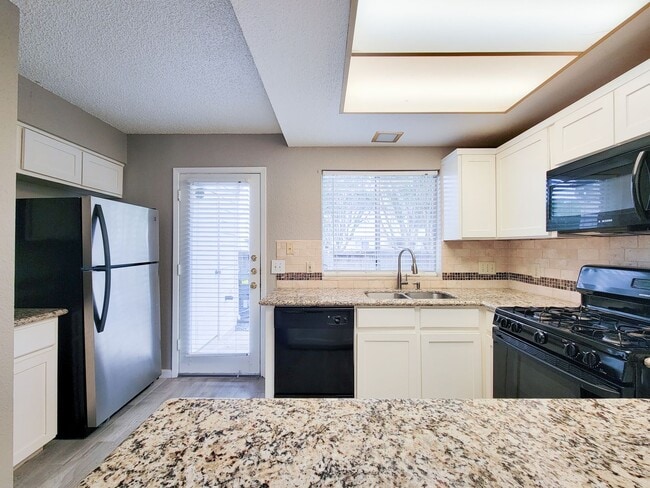 Building Photo - Welcome to This Charming Townhome Nestled ...