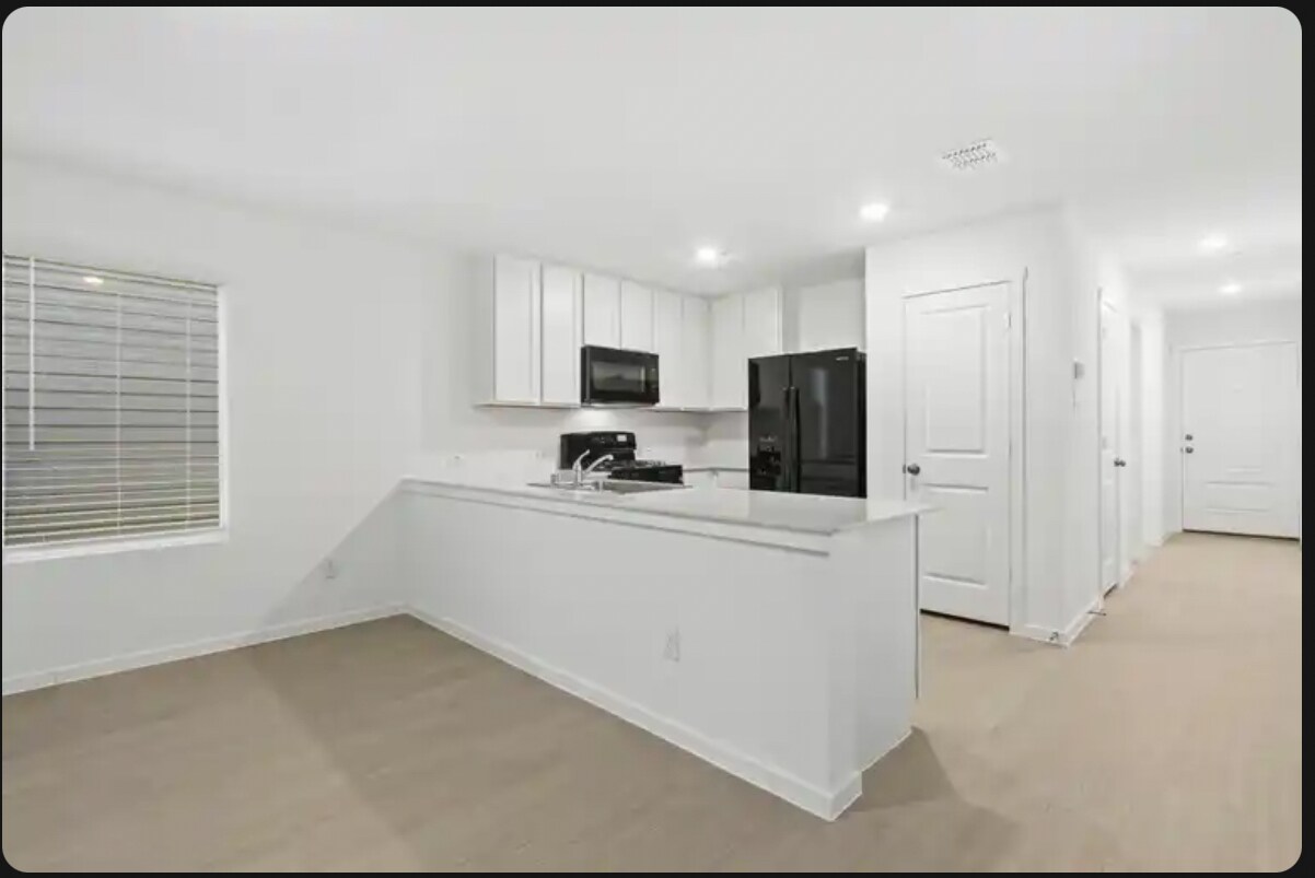 View from living room into kitchen - 726 Sandhill Crane Ln
