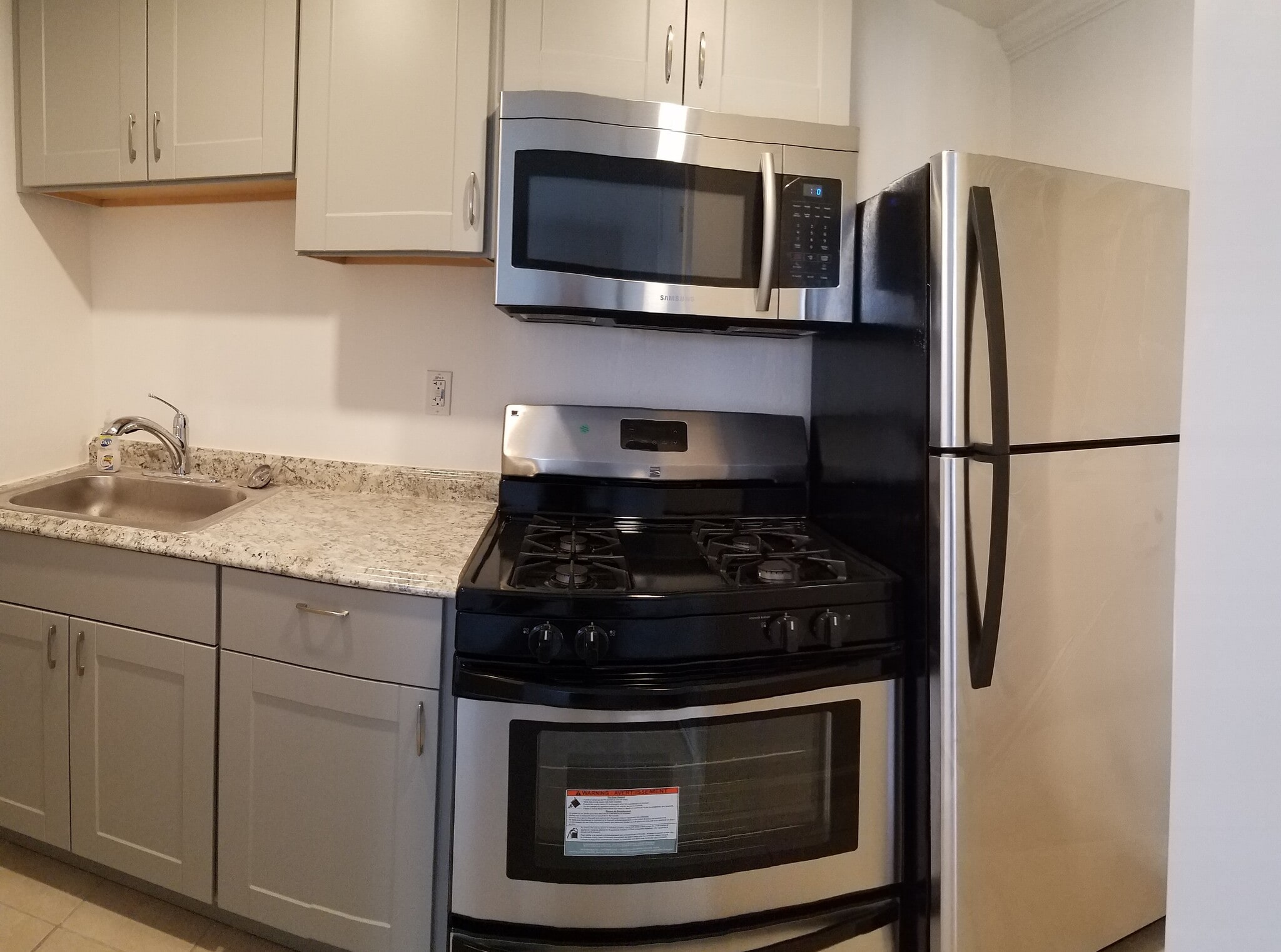 Brand new kitchen with stainless steel appliances include full size fridge, ventless microwave vent hood, gas operated stove, new back splash, and soft close hinges - 830 Spruce Ct