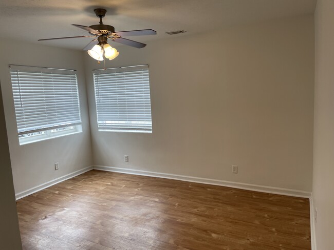 Master bedroom with ceiling fan and large closet - 2000 Central Ave