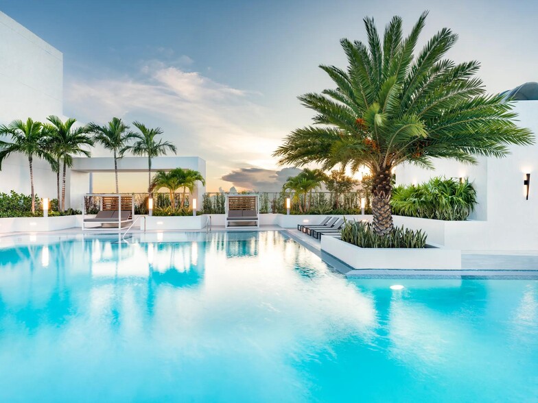 Sunset reflections and tropical palms make Modera Riverside’s rooftop pool an elegant Miami destination. - Modera Riverside