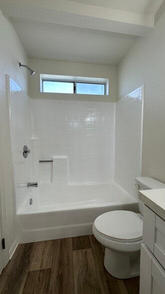 Bathrooms have shower tubs with upper windows for ventilation. - 939 Sapphire St