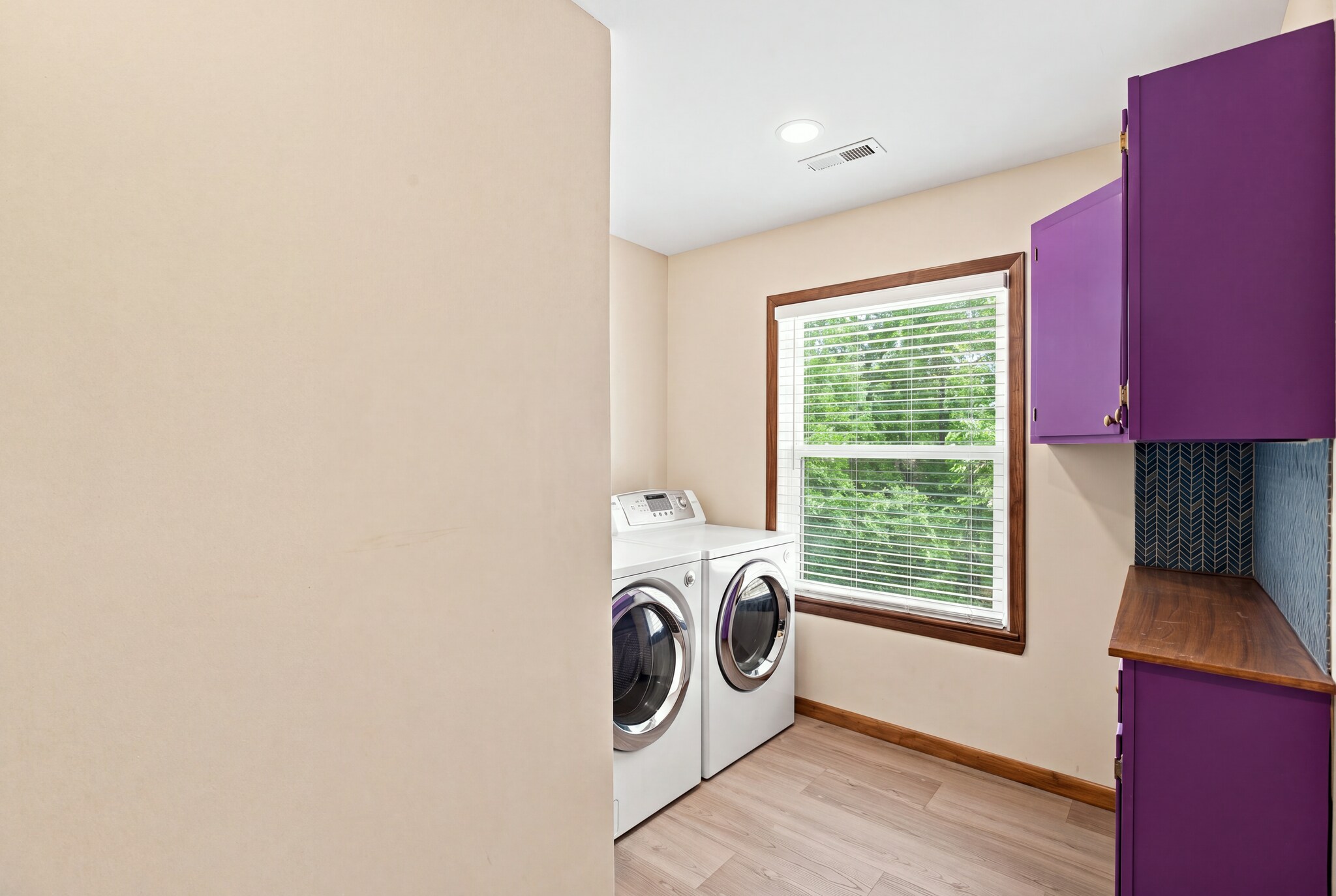 large laundry room with cabinet storage - 9227 Amos Road