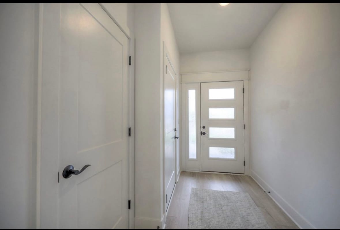 Elegant front door with contemporary detailing, offering a stylish first impression and enhanced cur - 22907 W 72nd Ter