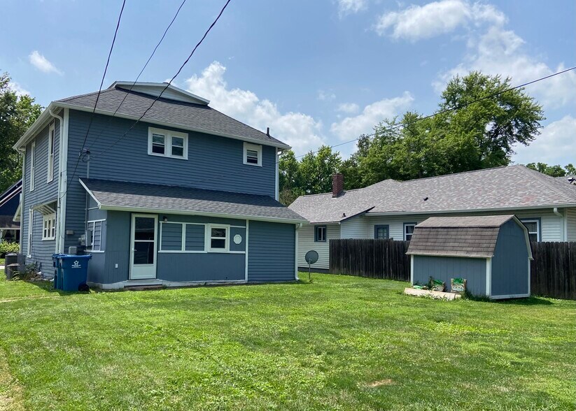 Backyard looking at back of house. Door leads to shared laundry room. - 1394 Wayne St