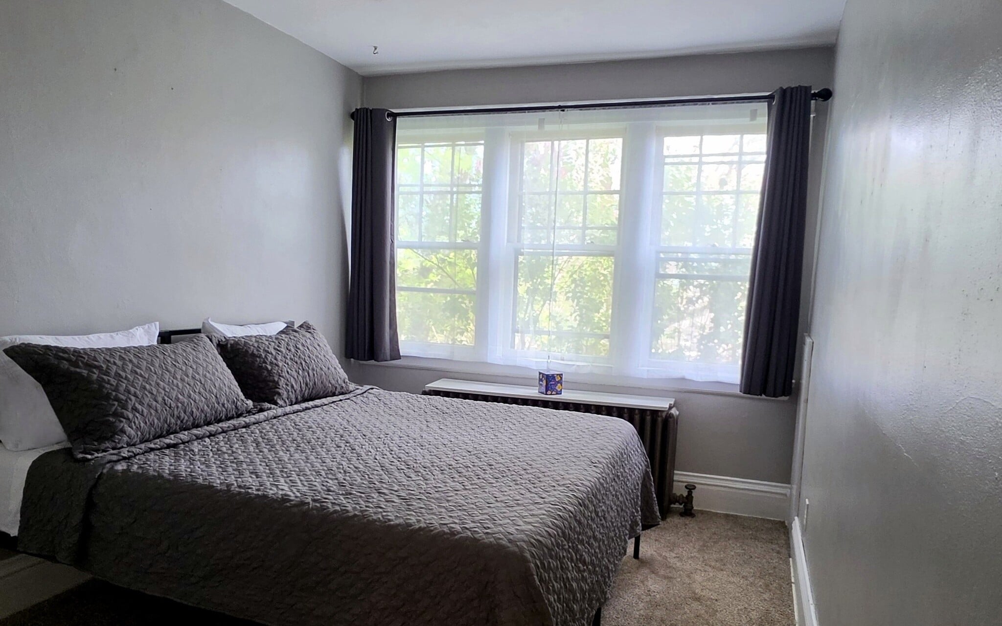 Comfortable primary bedroom featuring a King bed setup and large windows for natural light. - 822 E 4th St