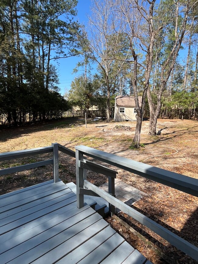 Building Photo - 3/2  home fenced in backyard located acros...