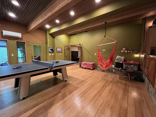 Building Photo - One-of-a-Kind Custom Home with Wall of Windows, Stone Fireplaces, Expansive Entertainment Space &...