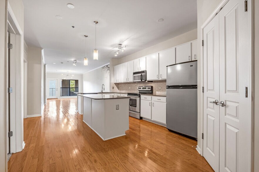 Kitchen with a ton of storage and dimmable lighting over the island - 1803 Broadway