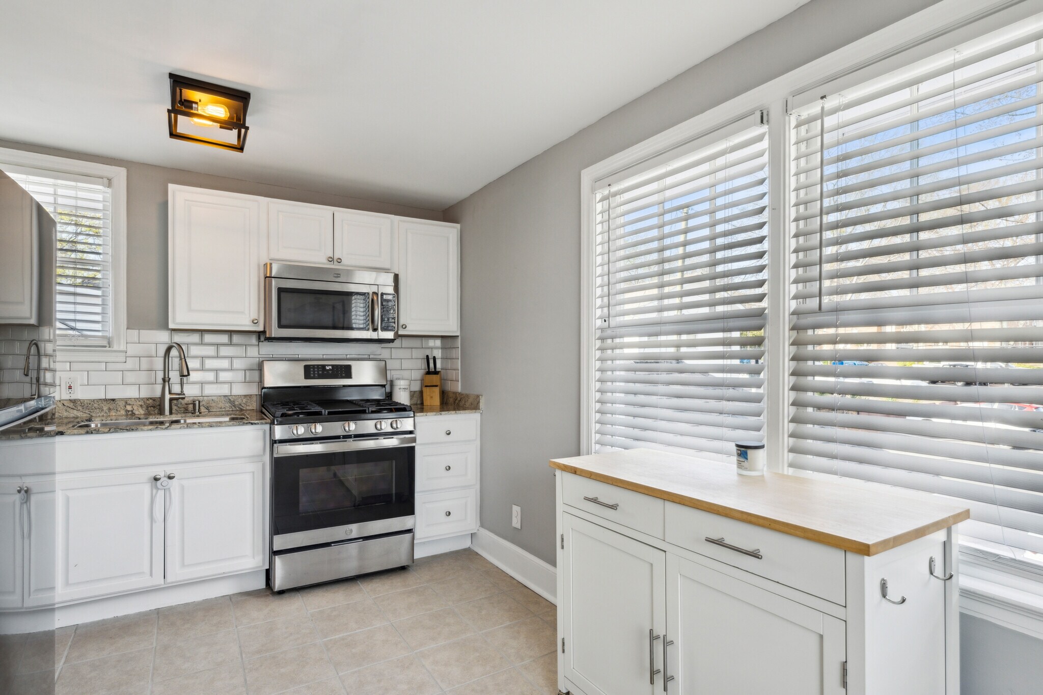 Large eat in kitchen includes gas stove, dishwasher, microwave and ample storage - 1118 Colquitt Ave NE