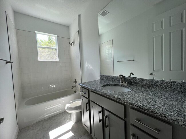 Building Photo - This Charming Brand-New Home is a 4/3 with...