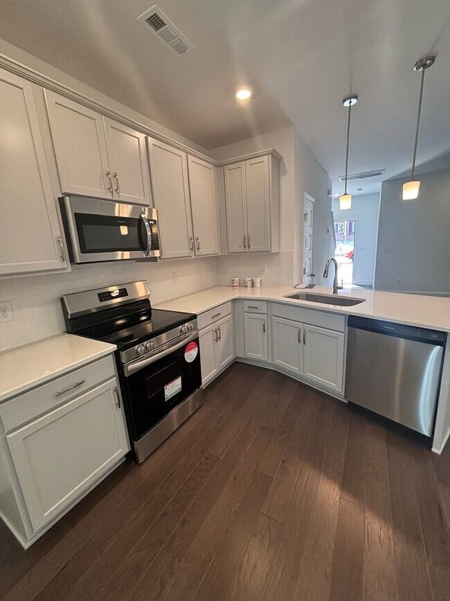Building Photo - **BE THE LUCKY ONE TO LIVE IN THIS 2024-BUILT END-UNIT TOWNHOME IN A RESORT-STYLE COMMUNITY**