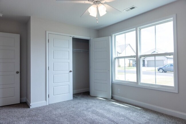 Building Photo - Modern Living Redefined with Stone Fireplace, Gray Cabinetry, Spa Inspired Primary Suite and Cove...