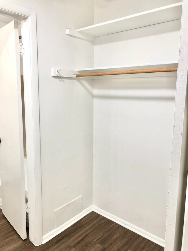 Experience ample storage with this walk-in closet, perfect for organizing your wardrobe. - GRACE LANDINGS APARTMENTS