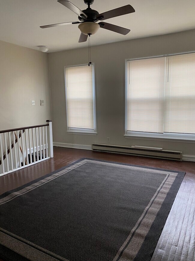 Livingroom Large windows overlooking Main St. - 114 E Main St