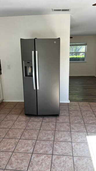 Kitchen featuring stainless steel fridge and light tile patterned flooring - 5906 Wagon Bnd
