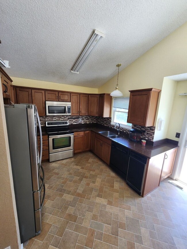 Building Photo - Spacious 4-Bedroom Home with RV Parking in...