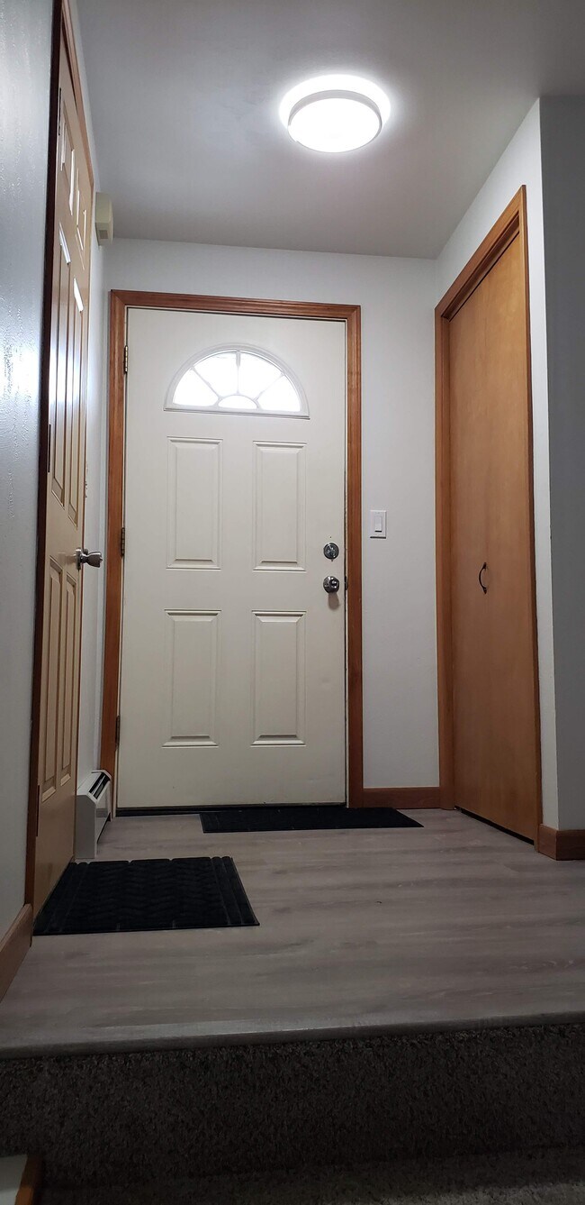 Front foyer (ground level) with coat closet and direct garage access. - 2340 S Ridge Rd