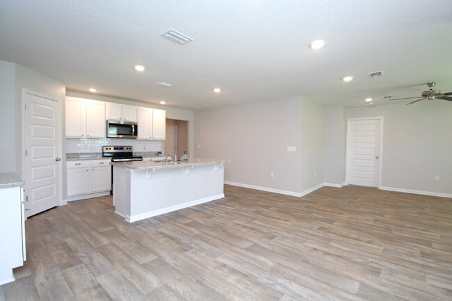 Building Photo - Coming Available Soon – 4BR/2BA Brick Home with Open Floor Plan, Solar Panels & 2-Car Garage in L...