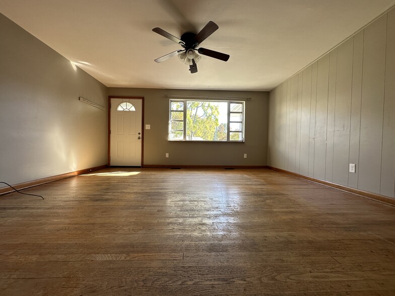 Living Room with hardwood floors and ceiling fan - 6120 Pinedale Dr