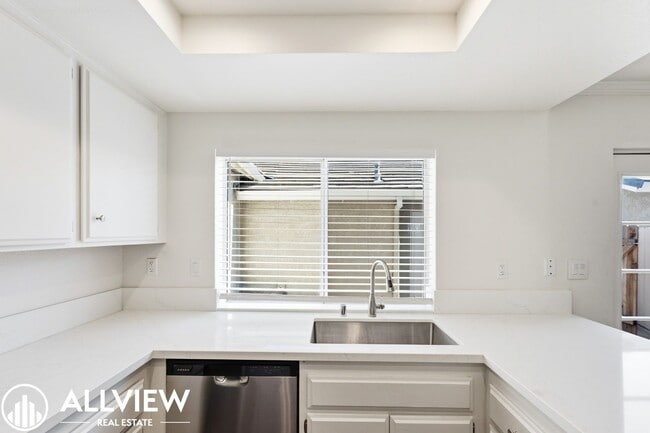 Building Photo - Fully Renovated 2 Bed Townhome with Private Patio, 2-Car Garage & Community Pool