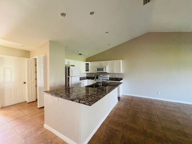 Building Photo - Experience this Cape Coral 3 bedroom 2 bath corner duplex with 1 car garage and screened in lanai.