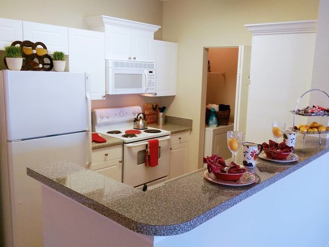 Kitchens with white appliances are also available. Laundry room located at the end of the kitchen. - Pine Lake