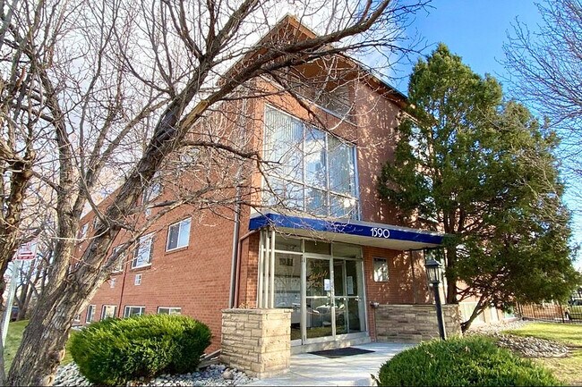 Welcome to your new home! This charming brick exterior offers a cozy facade framed by beautiful trees. - The Sloan