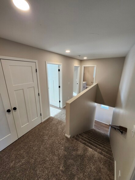 Upstairs landing looking to laundry space, second and third bedrooms and full bath - 5312 Welder Ave