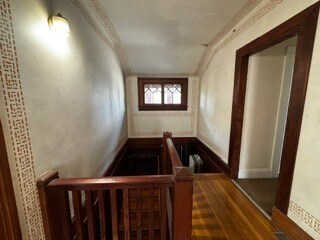 Foyer/stairwell with original Julia Morgan Stilling on plaster walls - 2615 Parker St