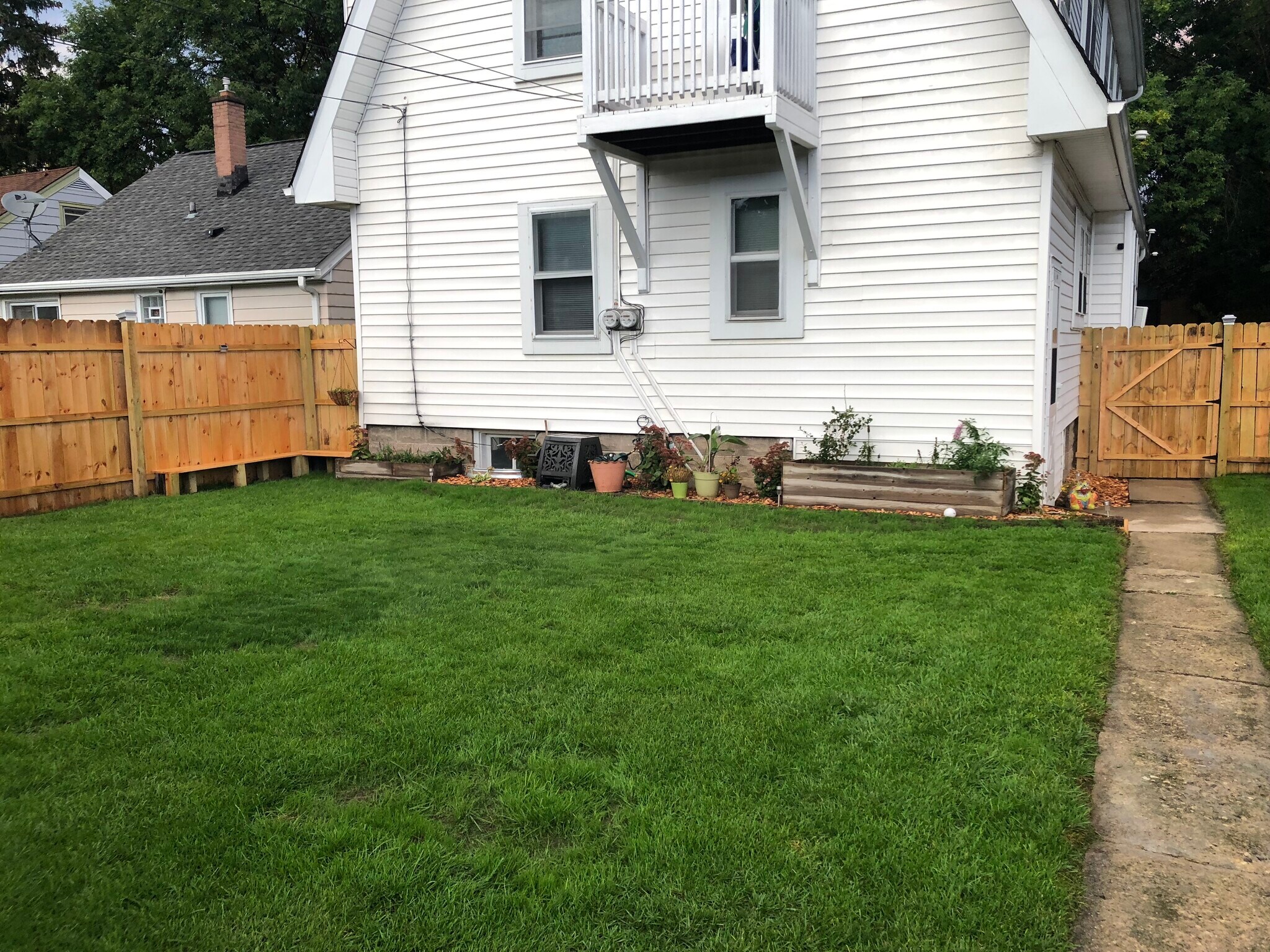 Balcony on back of the house with a fenced in yard - 623 S 60th St
