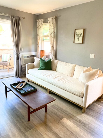 Living room with spacious sofa, coffee table, air conditioning unit. - 220 Woodland Pky
