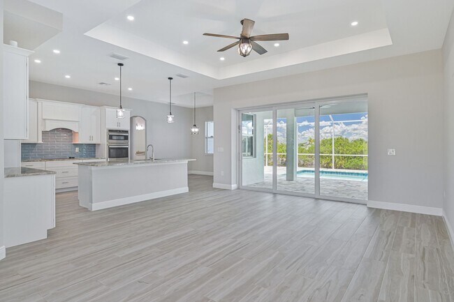 Building Photo - NOW AVAILABLE - Gorgeous Pool Home ~ NW Cape ~ 3 Car Garage ~ On Canal!