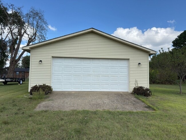 Building Photo - Spacious three bedroom, two bathroom with covered back porch and detached garage located on Cave ...