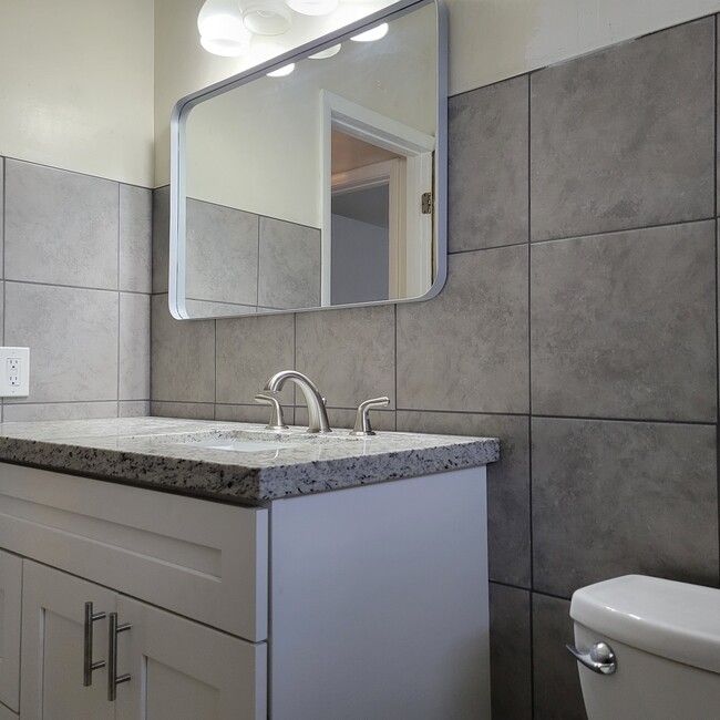 new granite top vanity and mirror - 2031 NE 56th St