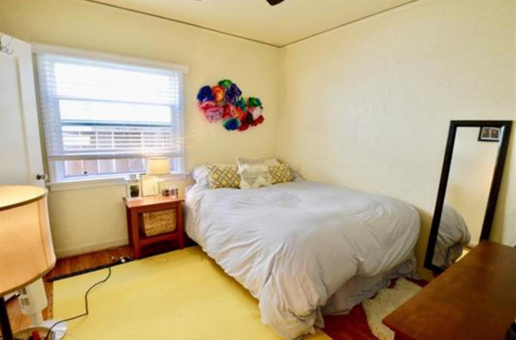 Bedroom 1 with large window, ceiling fan and closet - 4770 Bancroft St