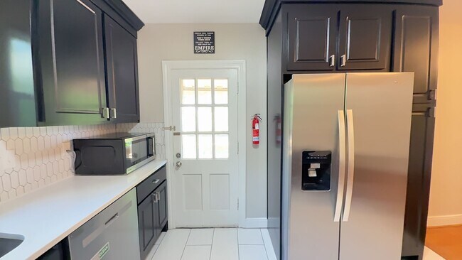Building Photo - Charming 2BR with Sunroom, Hardwood Floors & Lawn Care Included