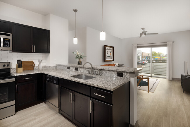 Renovated Package II Kitchen, living and dining area with hard surface flooring throughout and pendant lighting - AVA South End