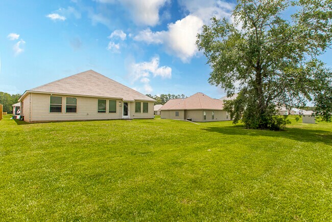 View from the right side of the backyard looking to the right side of the house and back door - 48465 Red Fox Dr