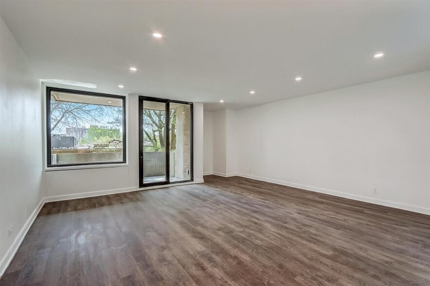 Living room with floor to ceiling windows and large balcony! - 240 M St SW