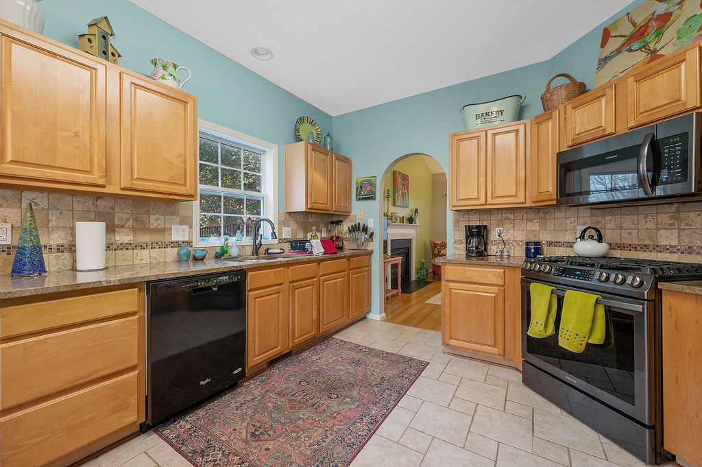 Kitchen with Granite and tile floors and backsplash - 2412 Laurel Falls Ln