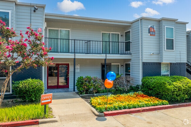 Leasing Office Exterior – Professional leasing office with welcoming entry and bright flowers. - Villa Rosita Apartments