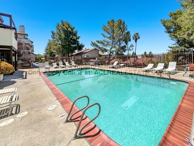 Building Photo - Bright 2BR/2BA Condo with Garage & Pool in...