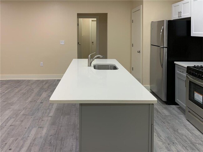 stone counter in central living space with living room and kitchen - 601 Northampton St