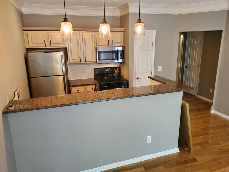 Kitchen with white subway title. - 6126 Inishmore Ln