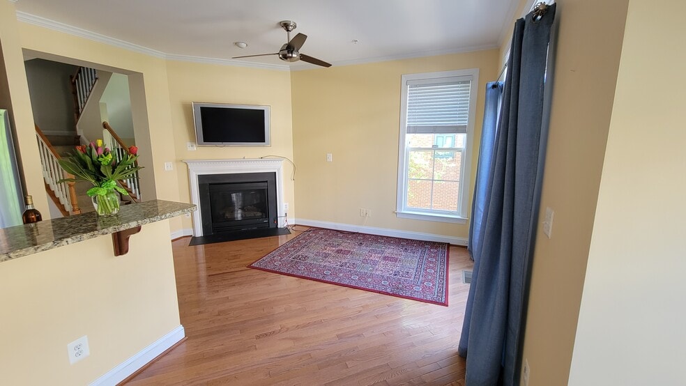 Sitting area off kitchen with fireplace - 222 Herndon Station Sq