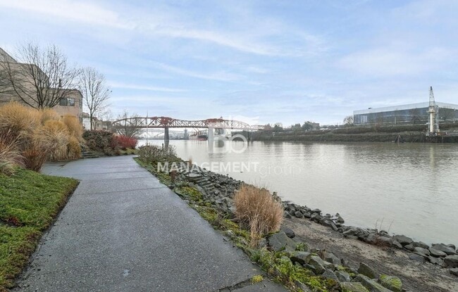 Building Photo - Spacious Riverfront Condo- Beautiful Condo w/River View from Bedroom! Parking Included!